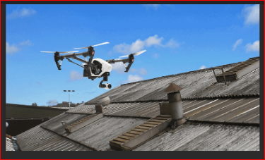 Drone inspecting industrial roof